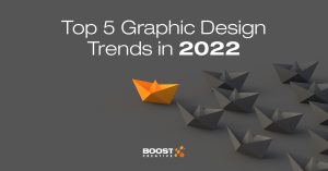Graphic with text "Top 5 Graphic Design Trends in 2022" against gray background, Boost Creative logo at the bottom and a trail of gray origami following one orange origami