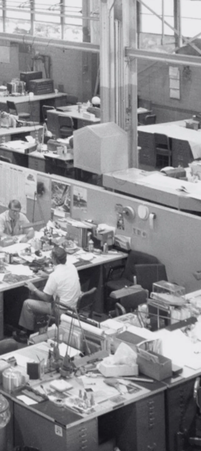 Team working at desks in a busy office workspace, representing collaboration and flexible engagement models.