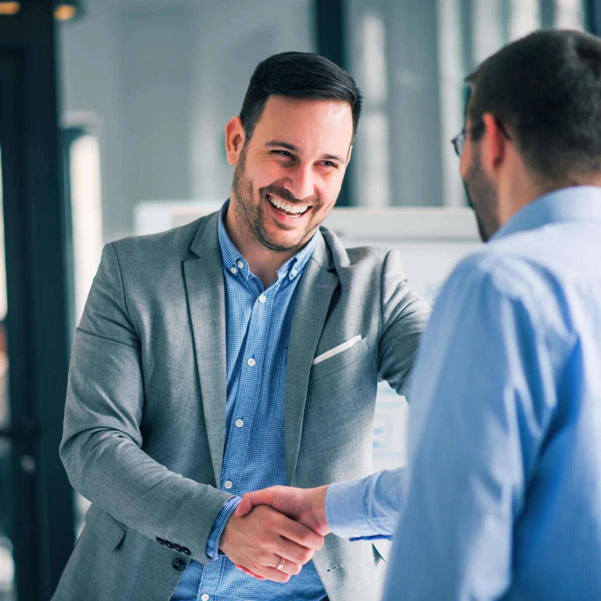 Small business owner shaking hands with a marketing agency partner