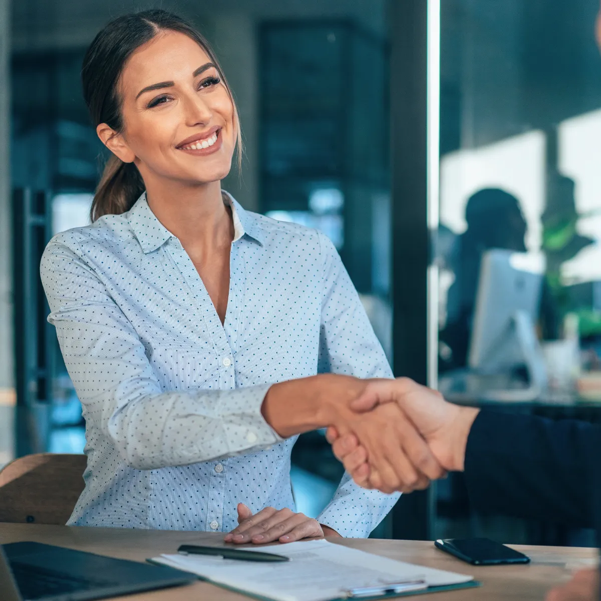 Business professional shaking hands during meeting about AI search and SEO strategy