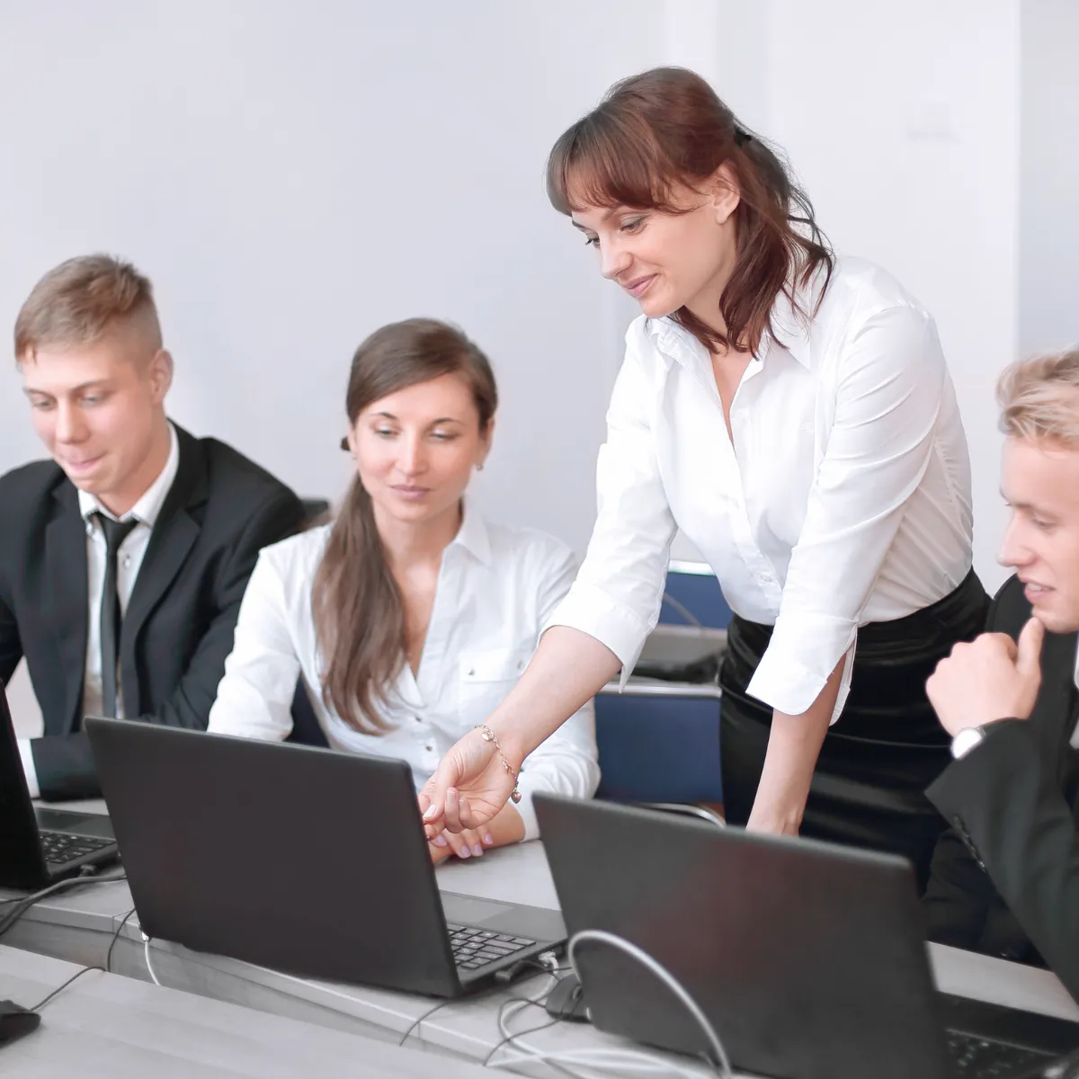 Business team reviewing pest control marketing performance on laptops